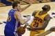 Cleveland Cavaliers forward LeBron James (23) loose the ball as he's hilt by Golden State Warriors forward David Lee (10) during the second half of Game 4 of basketball's NBA Finals in Cleveland, Thursday, June 11, 2015. (AP Photo/Paul Sancya)