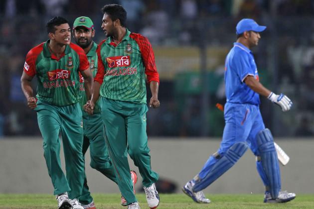 Bangladesh’s Shakib Al Hasan, second right, celebrates with teammates Taskin Ahmed, left, and Tamim Iqbal, second left,  the dismissal of India’s captain MS Dhoni, right, during the first one-day international cricket match between them in Dhaka, Bangladesh, Thursday, June 18, 2015. (AP Photo/ A.M. Ahad)