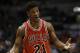 Chicago Bulls' Jimmy Butler talks to a teammate during Game 3 of the NBA basketball playoffs against the Milwaukee Bucks Thursday, April 23, 2015, in Milwaukee. (AP Photo/Aaron Gash)