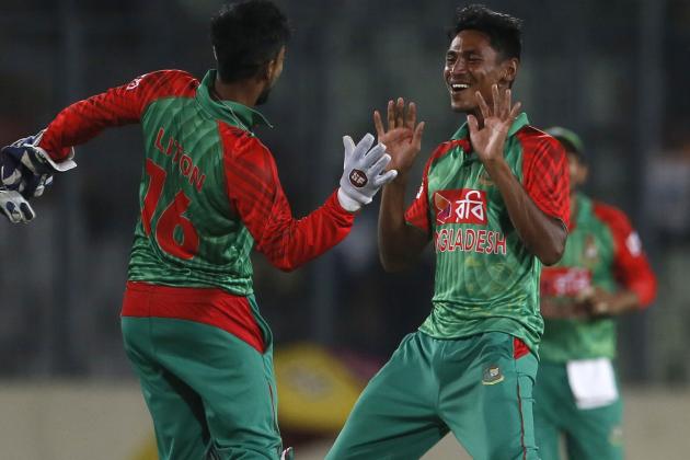 Bangladesh’s Mustafizur Rahman, right, celebrates with his teammate Litton Das,  the dismissal of India’s Ravindra Jadeja during their second one-day international cricket match in Dhaka, Bangladesh, Sunday, June 21, 2015. (AP Photo/ A.M. Ahad)