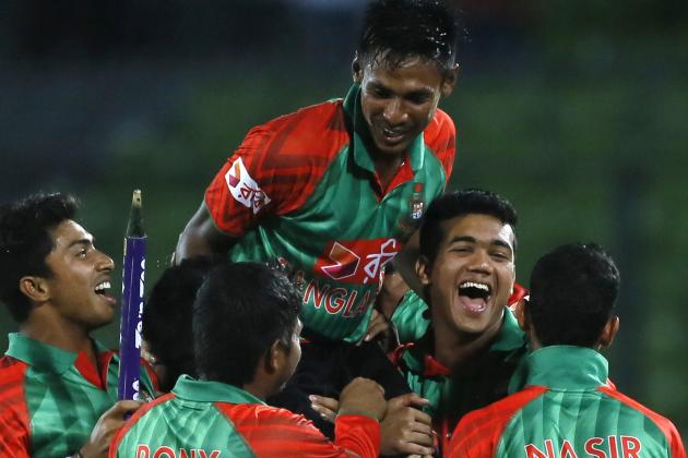 Bangladesh’s players lift Mustafizur Rahman, center, as they celebrate their win over India during their second one-day international cricket match in Dhaka, Bangladesh, Sunday, June 21, 2015. (AP Photo/ A.M. Ahad)