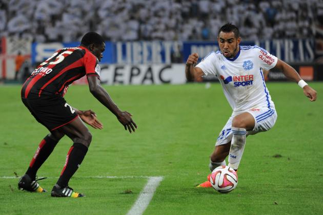 MARSEILLE, FRANCE - AUGUST 29:  Dimitri Payet of Marseille and Romain Genevois of Nice compete for the ball during the French Ligue 1 match between Olympique de Marseille and OGC Nice at Stade Velodrome on August 29, 2014 in Marseille, France.  (Photo by Kaz Photography/Getty Images)
