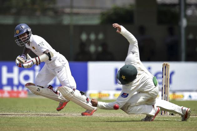 Sri Lanka's Kaushal Silva, left, takes off for a run as Pakistan's Azhar Ali tries to catch the ball during the second day of the second test cricket match between Sri Lanka and Pakistan in Colombo, Sri Lanka Friday, June 26, 2015. (AP Photo/Sanka Gayashan)