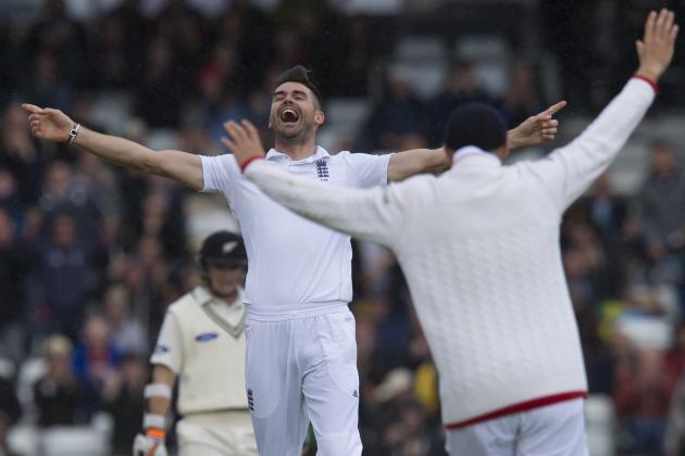 England's James Anderson, left, celebrates his 400th test wicket after taking the wicket of New Zealand's Martin Guptill, caught by Ian Bell for 0, on the first day of the second Test match between England and New Zealand at Headingley cricket ground in Leeds, England, Friday, May 29, 2015.(AP Photo/Jon Super)