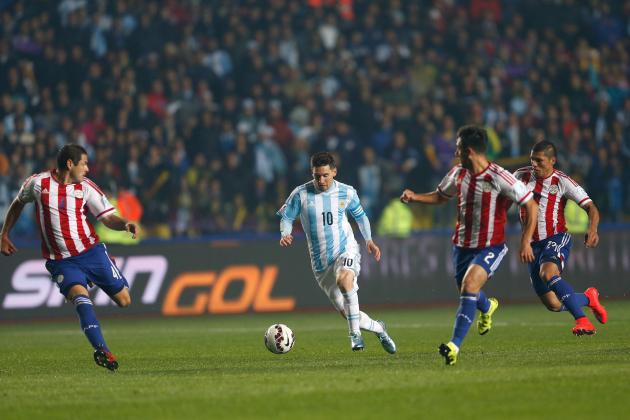 Argentina's Lionel Messi, center, runs with the ball through the Paraguay defense during a Copa America semifinal soccer match against Paraguay at the Ester Roa Rebolledo Stadium in Concepcion, Chile, Tuesday, June 30, 2015. Argentina won 6-1.(AP Photo/Andre Penner)