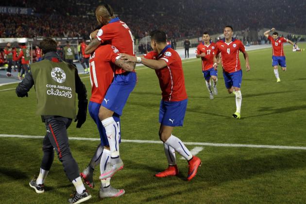 Chile's Eduardo Vargas , left,  celebrates with teammate Chile's Arturo Vidal after scoring Chile's second goal during a Copa America semifinal soccer match at the National Stadium in Santiago, Chile, Monday, June 29, 2015. (AP Photo/Ricardo Mazalan)