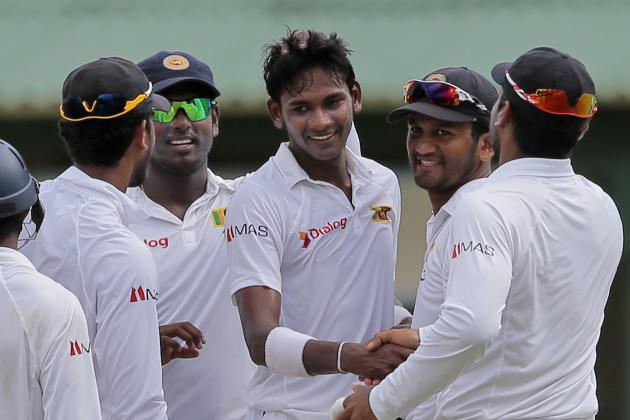 Sri Lanka's Dushmantha Chamera, center, celebrates his maiden test wicket with teammates during the first day of the second test cricket match against Pakistan in Colombo, Sri Lanka, Thursday, June 25, 2015. (AP Photo/Eranga Jayawardena)
