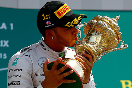 NORTHAMPTON, ENGLAND - JULY 05: Lewis Hamilton of Great Britain and Mercedes GP celebrates on the podium after winning the Formula One Grand Prix of Great Britain at Silverstone Circuit on July 5, 2015 in Northampton, England. (Photo by Dan Istitene/Getty Images)
