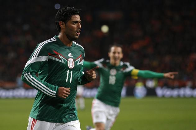 Mexico's Carlos Vela, left, celebrates scoring a goal during the international friendly soccer match between the Netherlands and Mexico at ArenA stadium in Amsterdam, Netherlands, Wednesday, Nov. 12, 2014. (AP Photo/Peter Dejong)