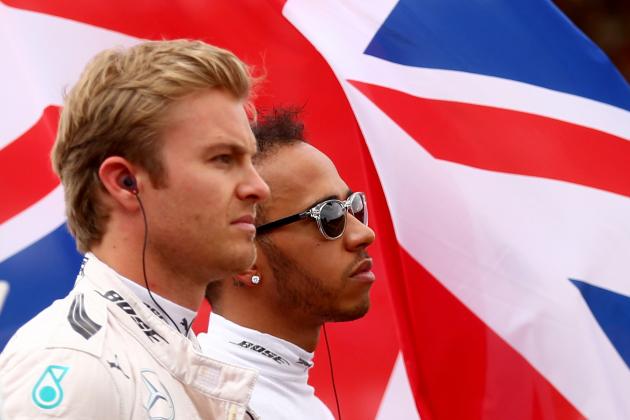 NORTHAMPTON, ENGLAND - JULY 05:  Lewis Hamilton of Great Britain and Mercedes GP and Nico Rosberg of Germany and Mercedes GP stand for the national anthem before the Formula One Grand Prix of Great Britain at Silverstone Circuit on July 5, 2015 in Northampton, England.  (Photo by Clive Rose/Getty Images)