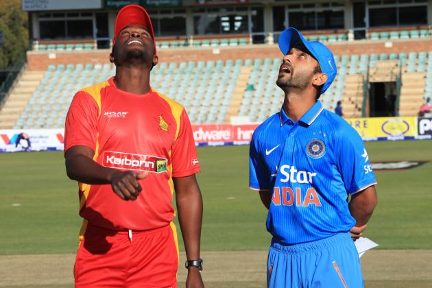 Zimbabwean captain Elton Chigumbura, left, and Indian captain Ajinkya Rahane attend the toss on the first day of the One Day International in Harare, Zimbabwe, Friday, July 10, 2015. (AP Photo/Tsvangirayi Mukwazhi)