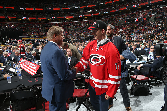 SUNRISE, FL - JUNE 26: Noah Hanifin shakws the hand of a member of the Carolina Hurricanes after being selected fifth overall by the Carolina Hurricanes during Round One of the 2015 NHL Draft at BB&T Center on June 26, 2015 in Sunrise, Florida. (Photo by Dave Sandford/NHLI via Getty Images)
