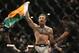 Conor McGregor celebrates after defeating Chad Mendes during their interim featherweight title mixed martial arts bout at UFC 189 on Saturday, July 11, 2015, in Las Vegas. (AP Photo/John Locher)