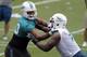 Miami Dolphins defensive tackle Ndamukong Suh, left, works on a drill with Ja'Wuan James (70) during an NFL football organized team activity, Monday, June 8, 2015, in Davie, Fla. (AP Photo/Lynne Sladky)
