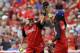 Aaron Boone celebrates with Snoop Dogg after Boone made a catch during the All-Star Legends & Celebrity Softball game, Sunday, July 12, 2015, in Cincinnati. (AP Photo/John Minchillo)
