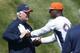 Denver Broncos defensive coordinator Wade Phillips, left, instructs outside linebacker DeMarcus Ware during the second day of the NFL football team's two-day voluntary veterans minicamp Wednesday, April 29, 2015, in Englewood, Colo. (AP Photo/David Zalubowski)