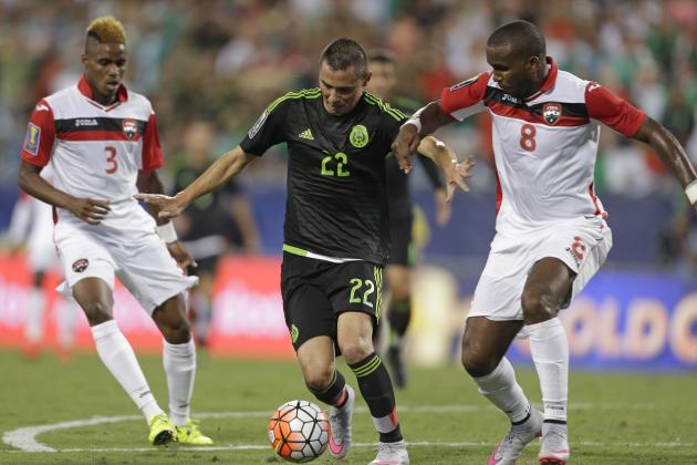 Mexico’s Paul Aguilar (22) drives between Trinidad & Tobago’s Khaleem Hyland (8) and Joevin Jones (3) during the first half of a CONCACAF Gold Cup soccer match in Charlotte, N.C., Wednesday, July 15, 2015. (AP Photo/Gerry Broome)