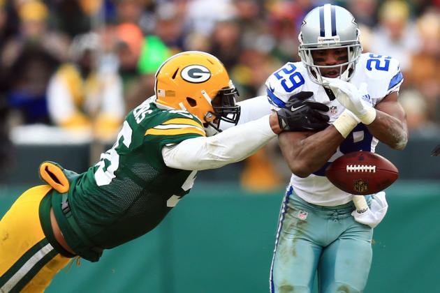 Jan 11, 2015; Green Bay, WI, USA; Dallas Cowboys running back DeMarco Murray (29) fumbles the ball as he is hit by Green Bay Packers outside linebacker Julius Peppers (56) in the third quarter in the second half in the 2014 NFC Divisional playoff football game at Lambeau Field. Mandatory Credit: Andrew Weber-USA TODAY Sports
