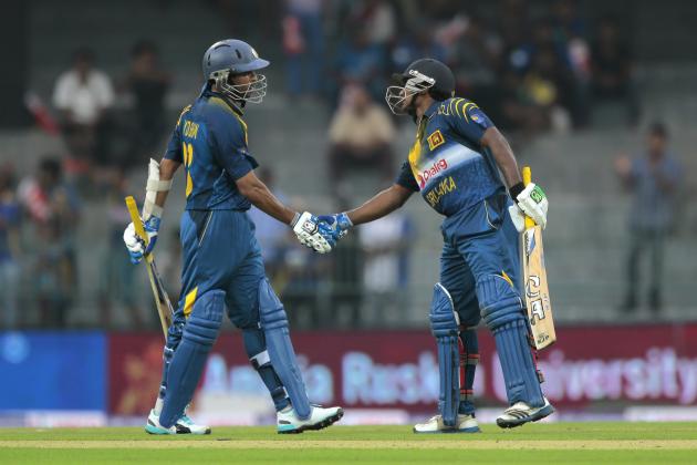Sri Lankan cricketers Tillakaratne Dilshan, left, and Kusal Janith Perera shakes hands as they complete a hundred-run partnership during the first one-day international cricket match between Sri Lanka and England  in Colombo, Sri Lanka, Wednesday, Nov. 26, 2014. (AP Photo/Eranga Jayawardena)