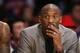 Los Angeles Lakers' Kobe Bryant, who is injured, sits on the bench in a suit against the New York Knicks during the first half of an NBA Basketball game, Thursday, March 12, 2015, in Los Angeles. (AP Photo/Danny Moloshok)