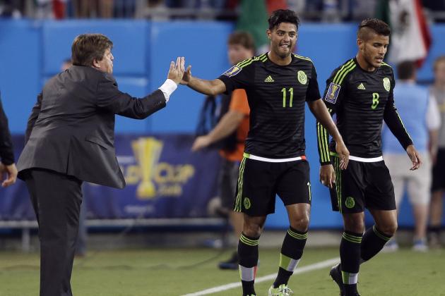 Mexico's Carlos Vela (11) is congratulated by coach Miguel Herrera, left, following Vela's goal against Trinidad and Tobago during the second half of a CONCACAF Gold Cup soccer match in Charlotte, N.C., Wednesday, July 15, 2015. Mexico's Jonathan dos Santos (8) walks away at right. The match ended in a 4-4 draw. (AP Photo/Gerry Broome)