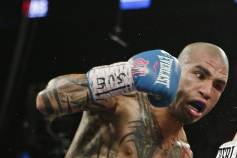 Miguel Cotto, left, of Puerto Rico, punches Daniel Geale, of Australia, during the second round of a boxing match Saturday, June 6, 2015, in New York. (AP Photo/Frank Franklin II)