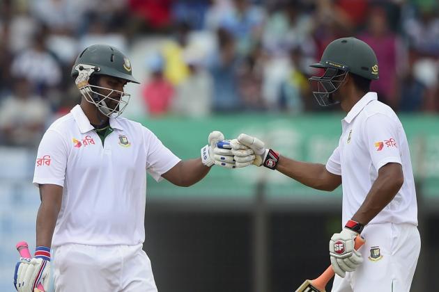 Bangladesh cricketer Tamim Iqbal (L) celebrates his half century (50 runs) with teammate Mohammad Mahmudullah (R) during the second day of the first cricket Test match between Bangladesh and South Africa at the Zahur Ahmed Chowdhury Stadium in Chittagong on July 22, 2015. AFP PHOTO/ Munir uz ZAMAN        (Photo credit should read MUNIR UZ ZAMAN/AFP/Getty Images)