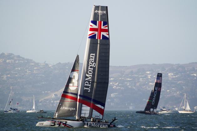 J.P. Morgan Ben Ainslie Racing of Great Britain, left, races against Oracle Team USA Coutts, right, in the first of two fleet races at the America's Cup World Series sailing event in San Francisco, Thursday, Oct. 4, 2012. Racing of the AC45 boats continues though Sunday on San Francisco Bay. J.P. Morgan Ben Ainslie Racing won the first fleet race. (AP Photo/Eric Risberg)