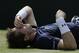 Britain's Andy Murray receives treatment during his doubles match against France's Jo-Wilfried Tsonga and Nicolas Mahut, during the quarterfinal matches of the Davis Cup at the Queen's Club in London, Saturday July 18, 2015. (AP Photo/Tim Ireland)