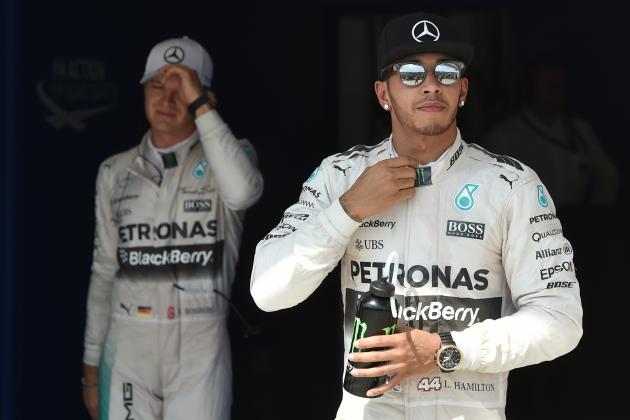 Mercedes AMG Petronas F1 Team's German driver Nico Rosberg (L) and Mercedes AMG Petronas F1 Team's British driver Lewis Hamilton react after the qualifying session at the Hungaroring circuit near Budapest on July 25, 2015, on the eve of the Hungarian Formula One Grand Prix. Defending world champion and series leader Lewis Hamilton bidding for a record fifth Hungarian Grand Prix victory will start from pole for Sunday's race after posting the fastest time in qualifying. 
AFP PHOTO / ANDREJ ISAKOVIC        (Photo credit should read ANDREJ ISAKOVIC/AFP/Getty Images)