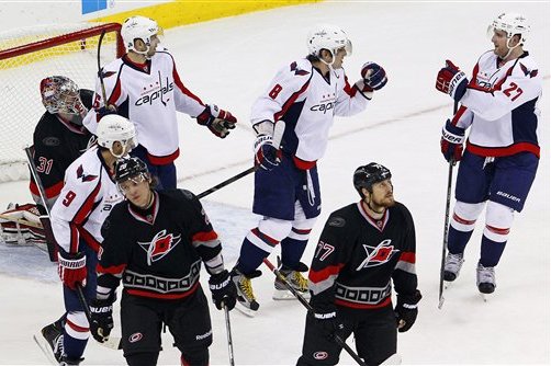 Washington Capitals' Alex Ovechkin (8), of Russia, celebrates a goal by teammate Mike Ribeiro (9) with Karl Alzner (27) and Eric Fehr (16) in front of Carolina Hurricanes goalie Dan Ellis (31) near Hurricanes' Alexander Semin (28), also of Russia, and Joe Corvo (77) during the third period of an NHL hockey game on Thursday, March 14, 2013, in Raleigh, N.C. The Capitals won 3-2. (AP Photo/Karl B DeBlaker)