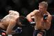 TJ Dillashaw, right, lands a punch to the head of Renan Barao during their bantamweight mixed martial arts title bout during UFC Chicago on Saturday, July 25, 2015, in Chicago. Dillashaw won in the fourth round. (AP Photo/Jeff Haynes)