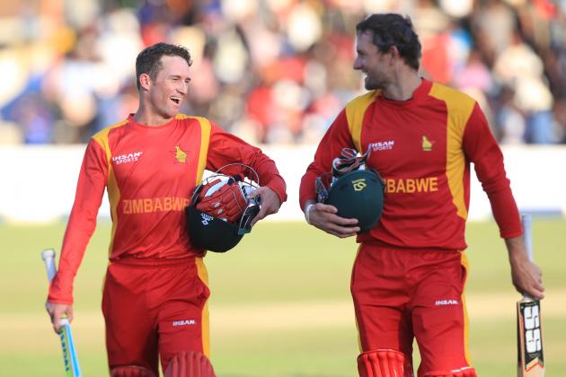 Zimbabwean batsmen Sean Williams, left, and Craig Ervine walk off the pitch after beating New Zealand during the One Day International Cricket match  in Harare, Sunday, Aug. 2, 2015.(AP Photo/Tsvangirayi Mukwazhi)