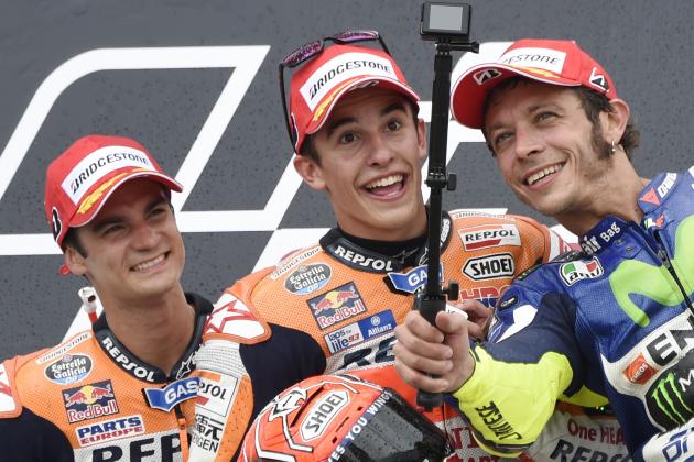 Spain’s Marc Marquez who won, center, Spain’s Dani Pedrosa who came in second, left, and Italy’s Valentino Rossi who finish second shoot a selfie on the podium after the MotoGP race at the Sachsenring circuit in Hohenstein-Ernstthal, Germany, Sunday, July 12, 2015. (AP Photo/Jens Meyer)