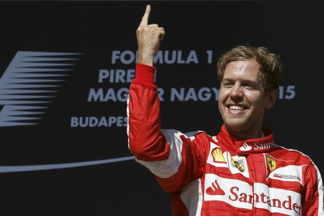 Ferrari driver Sebastian Vettel of Germany celebrates after winning the Hungarian Formula One Grand Prix in Budapest, Hungary, Sunday, July 26, 2015. (AP Photo/Darko Vojinovic)