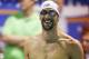 Michael Phelps stands by the blocks during introductions before swimming the 100 meter freestyle in the B final at the Arena Pro Swim Series meet in Charlotte, N.C, Sunday, May 17, 2015. Phelps finished eleventh with a time of 49.96. (AP Photo/Nell Redmond)