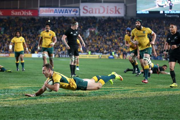 Australia's Nic White, center, scores a try against New Zealand during their Rugby Championship match in Sydney, Australia, Saturday, Aug. 8, 2015. (AP Photo/Rick Rycroft)