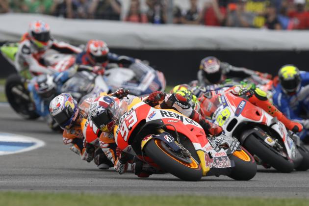 Marc Marquez, front, of Spain, takes a turn on his way to winning the Indianapolis Grand Prix at Indianapolis Motor Speedway in Indianapolis, Sunday, Aug. 9, 2015.  (AP Photo/Michael Conroy)