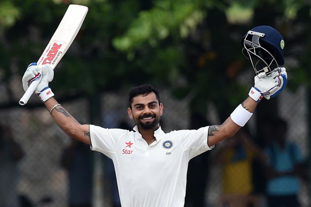 Indian cricket team captain Virat Kohli raises his bat after reaching a century (100 Runs) during the second day of the opening Test match between Sri Lanka and India at the Galle International Cricket Stadium in Galle on August 13, 2015. AFP PHOTO/ Ishara S. KODIKARA        (Photo credit should read Ishara S.KODIKARA/AFP/Getty Images)