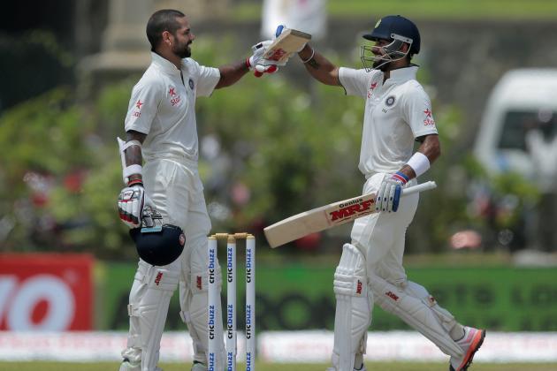 India's Shikar Dhawan, left, celebrates scoring a century with teammate Virat Kohli during the second day of their first test cricket match against Sri Lanka in Galle, Sri Lanka, Thursday, Aug. 13, 2015. (AP Photo/Eranga Jayawardena)