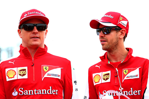 NORTHAMPTON, ENGLAND - JULY 05:  Sebastian Vettel of Germany and Ferrari speaks with Kimi Raikkonen of Finland and Ferrari during the drivers' parade before the Formula One Grand Prix of Great Britain at Silverstone Circuit on July 5, 2015 in Northampton, England.  (Photo by Mark Thompson/Getty Images)