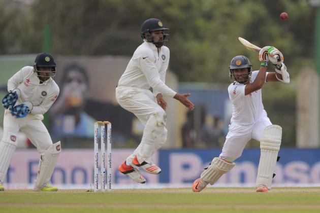 India's Rohit Sharma, center, jumps to avoid the ball being hit off a shot of Sri Lanka's Dinesh Chandimal, right, as wicketkeeper Wriddhiman Saha watches during the third day of the first cricket test match between India and Sri Lanka in Galle, Sri Lanka, Friday, Aug. 14, 2015. (AP Photo/Eranga Jayawardena)