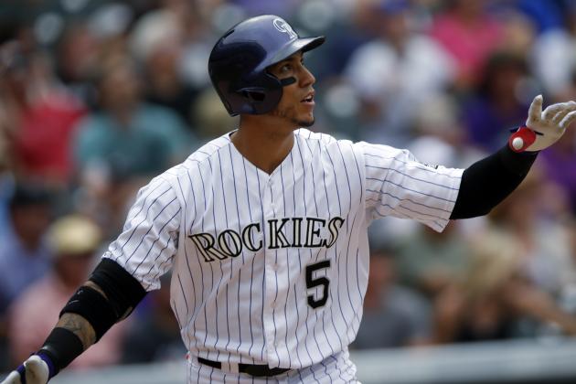 Colorado Rockies' Carlos Gonzalez follows the flight of his solo home run off San Diego Padres starting pitcher Ian Kennedy in the fourth inning of a baseball game Sunday, Aug. 16, 2015, in Denver. The Rockies won 5-0. (AP Photo/David Zalubowski)