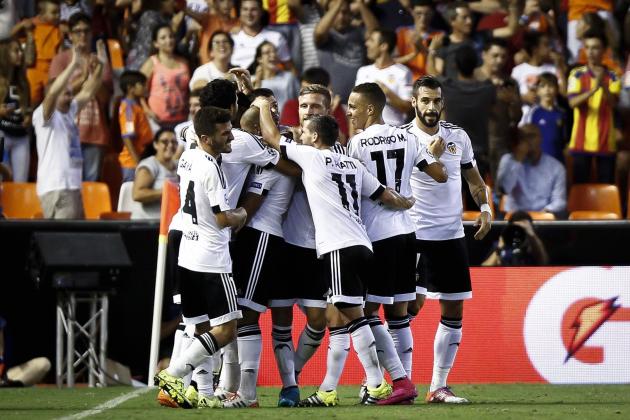 Valencia players celebrate after scoring during the UEFA Champions League playoff football match between Valencia CF vs AS Monaco FC at the Mestalla stadium in Valencia on August 19, 2014.  AFP PHOTO/ BIEL ALINO        (Photo credit should read BIEL ALINO/AFP/Getty Images)