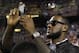 Basketball player LeBron James shoots a video with his cell phone from the sidelines before an NFL football game between the Dallas Cowboys and Washington Redskins in Landover, Md., on Sunday, Sept. 12, 2010. (AP Photo/Evan Vucci)