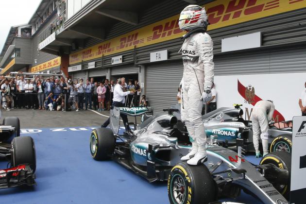 Mercedes driver Lewis Hamilton of Britain stands on his car after winning the Belgium Formula One Grand Prix, at the Spa-Francorchamps circuit, Belgium, Sunday, Aug. 23, 2015.  (AP Photo/Luca Bruno)