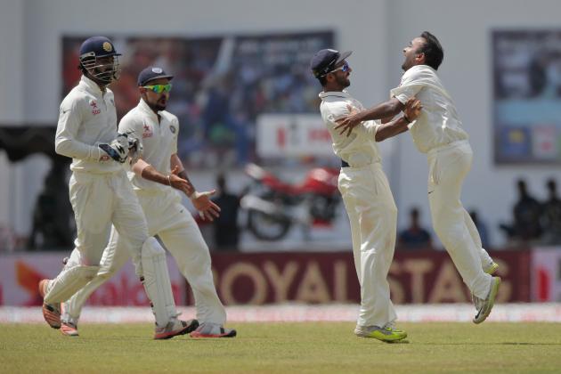 India's Amit Mishra, right, celebrates taking the wicket of Sri Lanka's Dinesh Chandimal, unseen, with his teammates  during the fifth day of the second test cricket match between Sri Lanka and India in Colombo, Sri Lanka, Monday, Aug. 24, 2015. (AP Photo/Eranga Jayawardena)