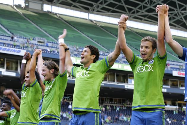 Seattle Sounders players Thomas, right, Nelson Valdez, second from right, and Erik Friberg, third from right, celebrate after they defeated Orlando City 4-0 in an MLS soccer match, Sunday, Aug. 16, 2015, in Seattle. (AP Photo/Ted S. Warren)