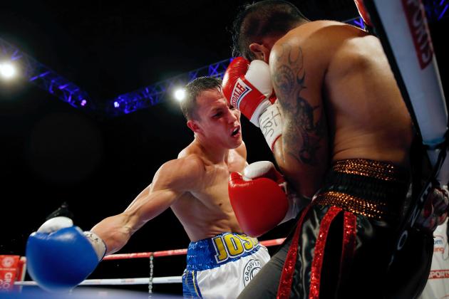 LEEDS, ENGLAND - APRIL 11: Josh Warrington (L) of Leeds in action with Dennis Tubieron of the Philippines during the vacant WBC International Featherweight Championship fight at the First Direct Arena on April 11, 2015 in Leeds, England. (Photo by Paul Thomas/Getty Images)