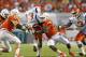 MIAMI GARDENS, FL - SEPTEMBER 21: Al-Quadin Muhammad #98 of the Miami Hurricanes sacks Antonio Bostick #13 of the Savannah State Tigers on September 21, 2013 at Sun Life Stadium in Miami Gardens, Florida. (Photo by Joel Auerbach/Getty Images)